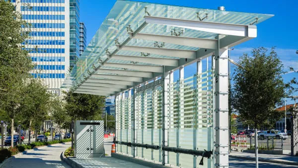 White metal and glass bus shelter at station with separated bus lane in downtown Houston, Texas