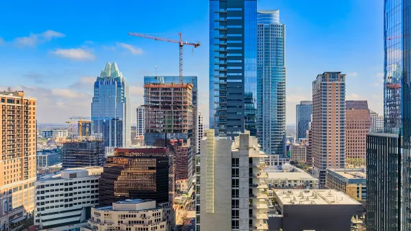Downtown Austin, Texas skyline with cranes on a sunny day.