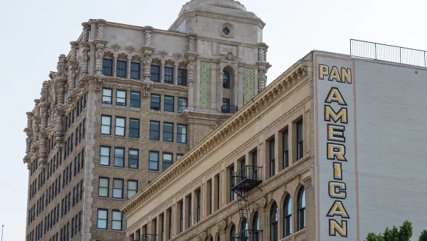 Historic buildings in downtown Los Angeles with large "Pan American Lofts" sign on side of building.