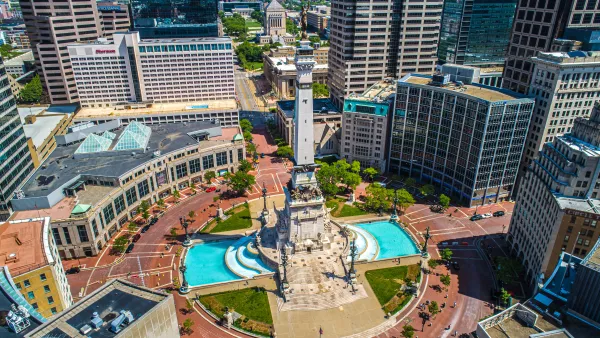 Aerial view of Monument Circle with tall statue on post in middle of traffic circle area in Indianapolis, Indiana