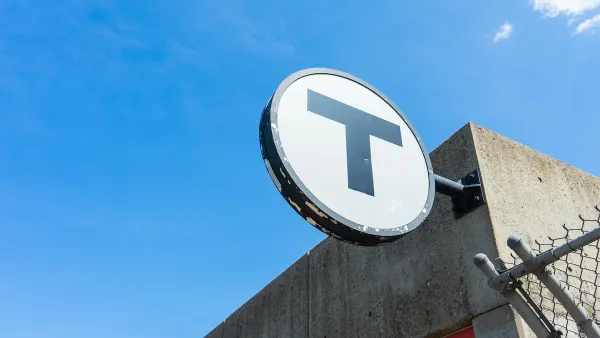 CLose-up of MBTA "T" logo on building.