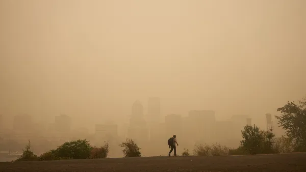 Hazy sky with Portland, Oregon skyline barely visible in background. Man walking in foreground.