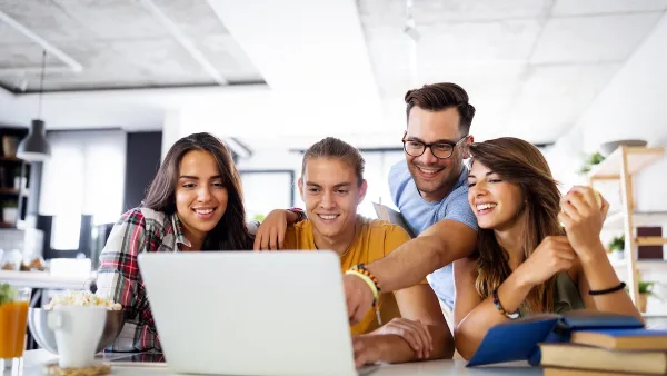 Group of young people enjoying group study at table.