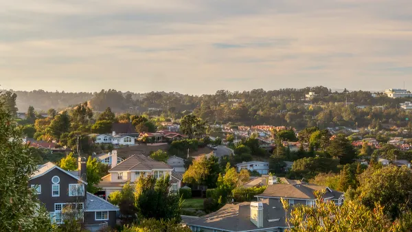 Aerial view of houses against partly cloudy sky in San Mateon County, California.