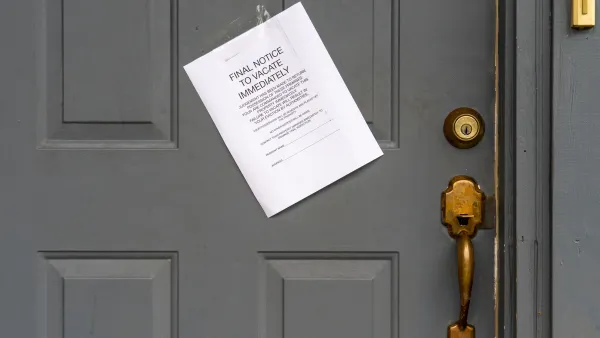 Eviction notice on white paper taped to grey door