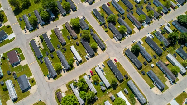 Aerial view of manufactured homes on green lawn.