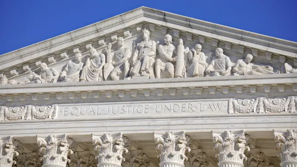 Close-up of U.S. Supreme Court building with "Equial Justice Under the Law" carving across top.