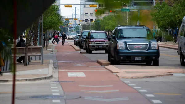 Red painted and curb-protected bike lane in downtown Austin, Texas.