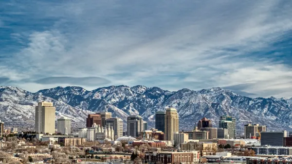 View of Salt Lake City, Utah skyline with snowy mountains in background.