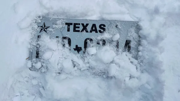 Texas license plate almost entirely covered by snow