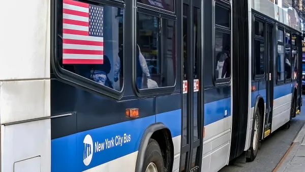 Close-up from back of blue and white New York City bus