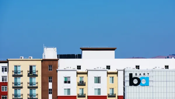Colorful multistory apartment buildings next to BART transit station in Pleasanton, California.