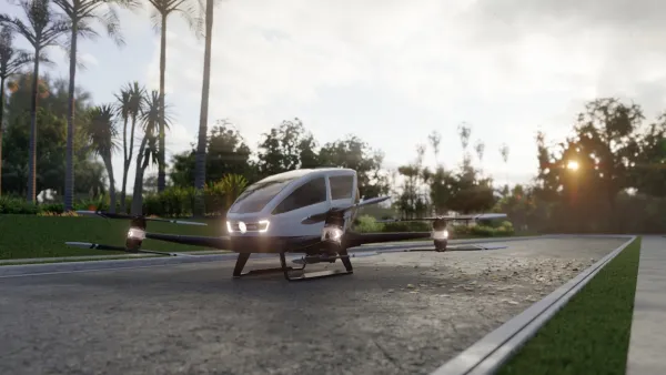 Rendering of small autonomous 'air taxi' parked on gray stone driveway.