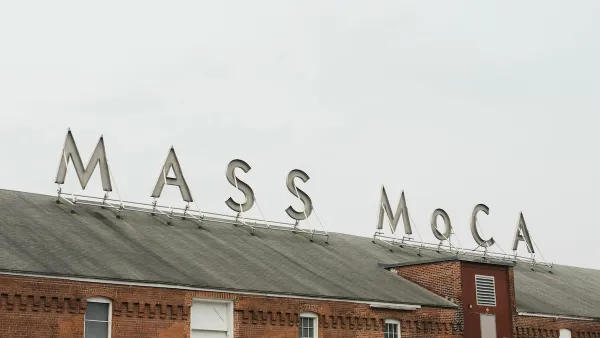 Sign for MASS MoCA on brick building.