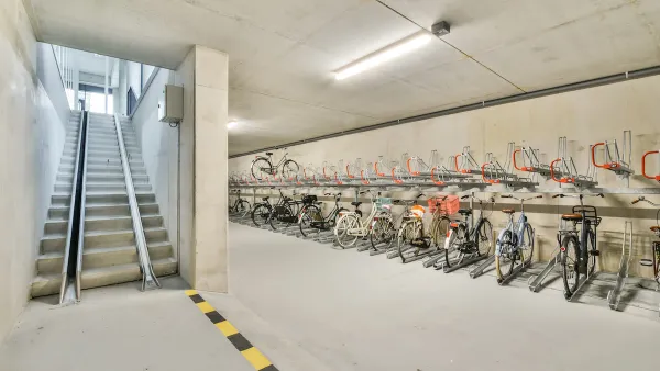 Bike parking in underground area with ramp for taking bikes upstairs.