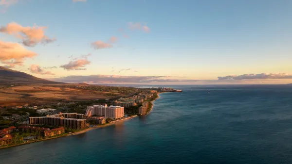 Aerial view of coast in Maui, hawaii with hotels and condo buildings at sunrise or sunset.