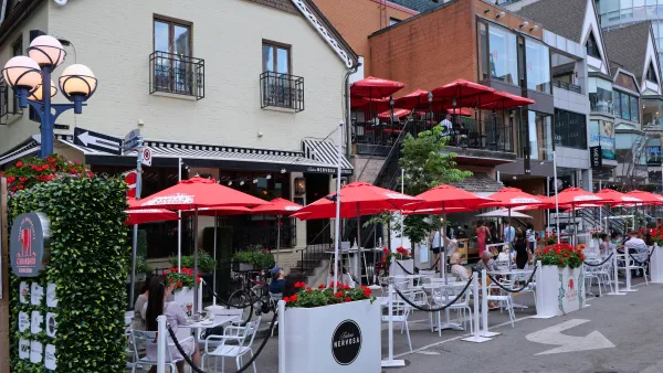 Outdoor dining patio with red umbrellas in Toronto, Canada