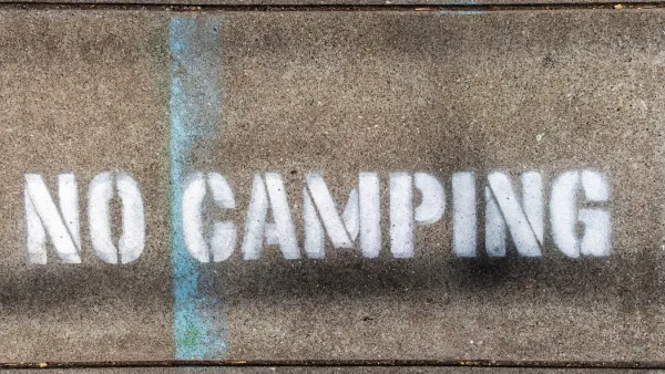 "No Camping" stencil on concrete.
