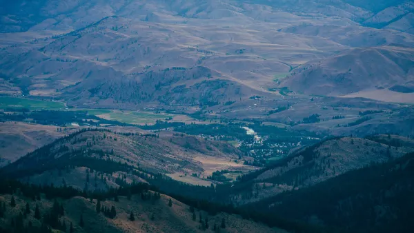 Aerial view of small rural community nestled in sprawling green valley in Washington State