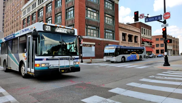 City bus in downtown Kansas City with brick buildings in background.