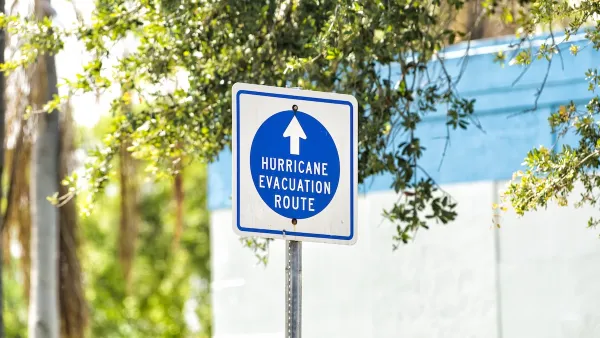 Blue and white "hurricane evacuation route" sign.