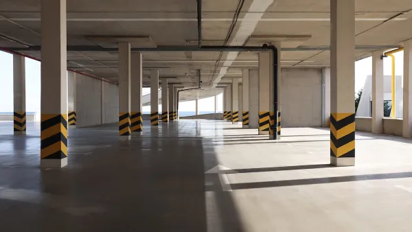 Empty elevated parking garage with sunlight coming in.