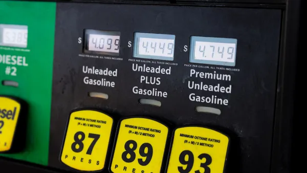 Close-up of gas pump with yellow buttons and price screens.