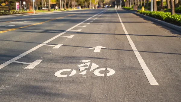 Bike lane marked with white paint on asphalt street.
