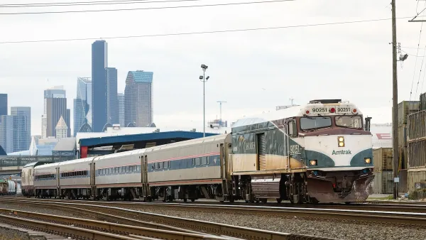 Amtrak train with downtown Seattle in background.