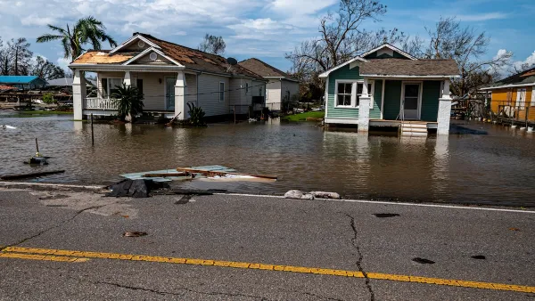 Two small wood homes with floodwaters in coastal Louisiana after Hurricane Ida.