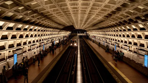 View from above platform in D.C. Brutalist subway station with people waiting on platforms