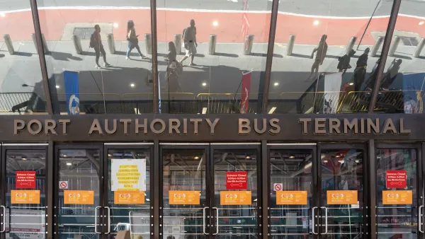 Entrance to Port Authority Bus Terminal with glass doors and sign in midtown Manhattan, New York City.