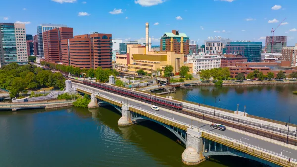 Cambridge Kendall Square skyline and MBTA red line train on Longfellow Bridge aerial view, Boston, Massachusetts MA, USA.