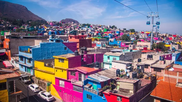 View of colorful dense buildings in Mexico City from aerial cable car.