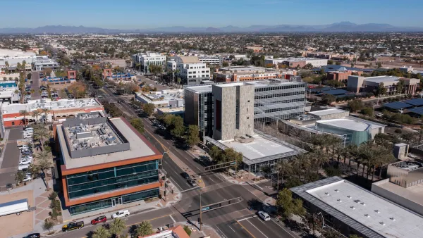Aerial view of downtown Chandler, Arizona with desert hills in background.