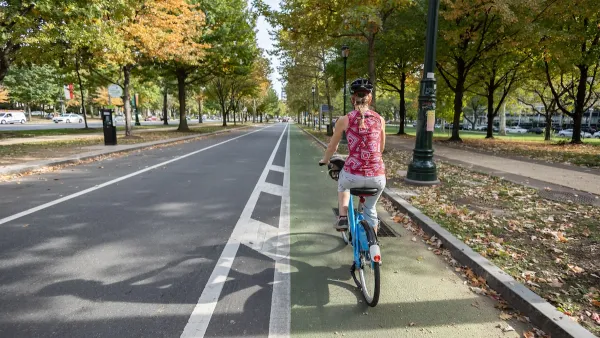 Woman rides a bike in green painted bike lane in Philadelphia, Pennsylvania.