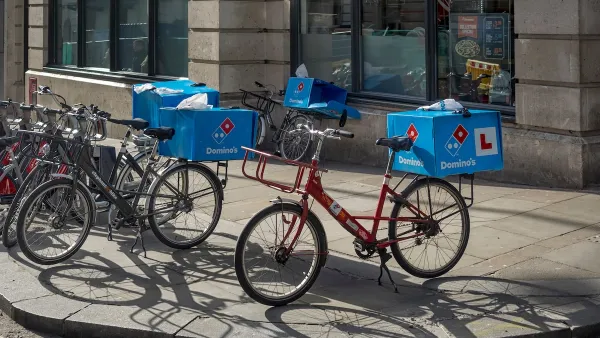 Domino's Pizza delivery bikes parked on a sidewalk in London, UK.