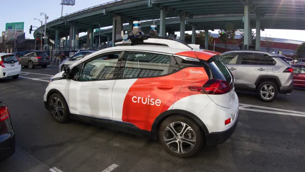White and red Cruise self-driving vehicle on a San Francisco street.