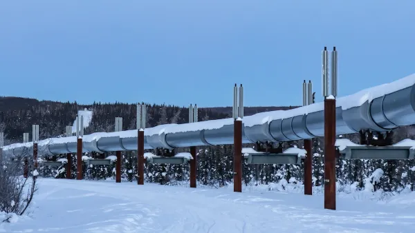 Silver oil pipeline running above ground in snowy area near Fairbanks, Alaska.
