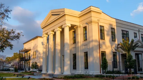 View of renovated Greek Revival Carrollton Courthouse at golden hour with new construction building next to it