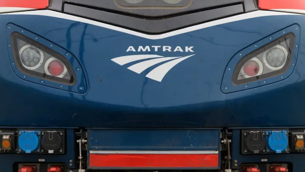 Close-up of front of blue locomotive with Amtrak logo.