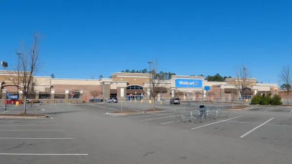 Large Walmart store with empty parking lot.