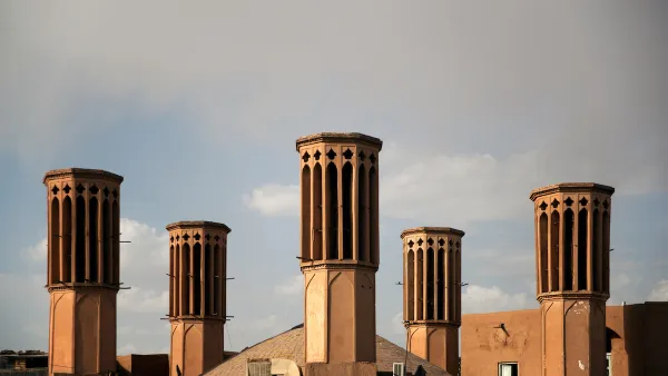 Elevated view of five windcatcher ventilation towers on rooftops in Yazd, Iran.