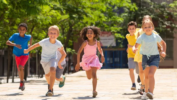 Group of children running outdoors toward camera.