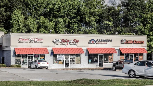 One-story strip mall with red awnings.