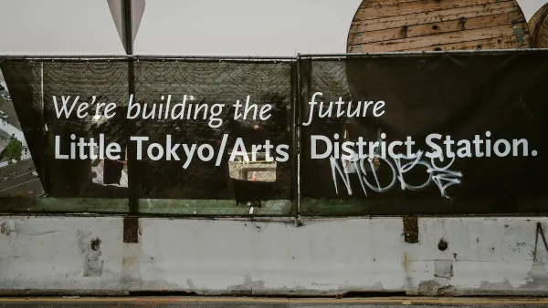 Black banner with white text "We're building the future - Little Tokyo/Arts District Station" in Los Angeles, California.