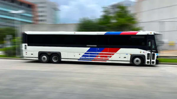 Houston Metro bus moving rapidly across blurred background.