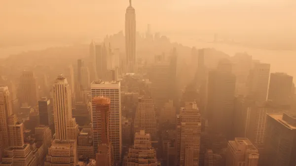 Aerial view of New York City including Empire State Building blanketed in orange wildfire smoke
