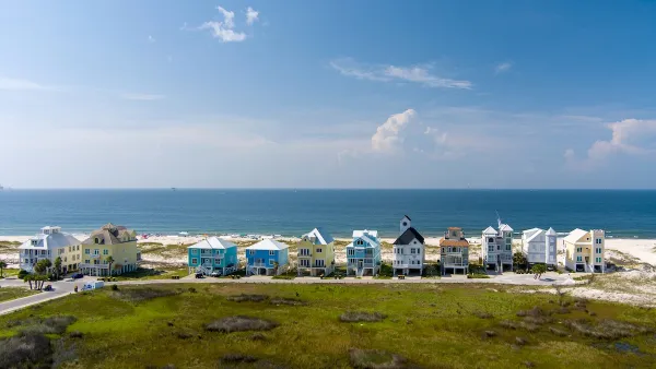 Row of colorful two-story beach homes on Gulf Coast beach in Alabama.