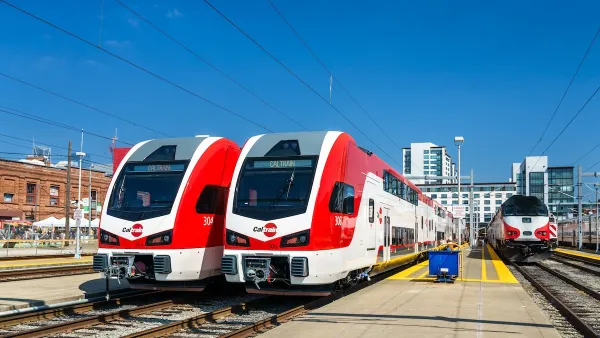 Two red and white electric trains, part of Caltrain fleet in San Francisco, California.